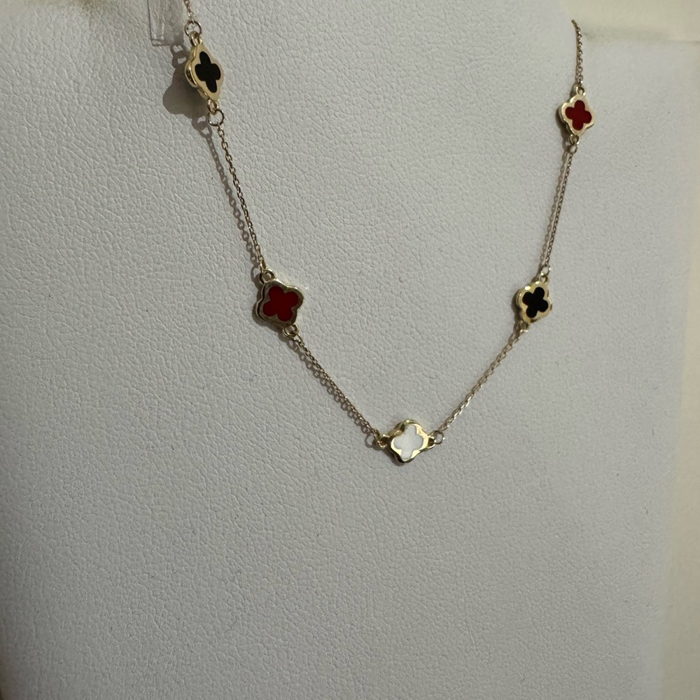 Elegant Gold Necklace with Red, Black, and White Accents
